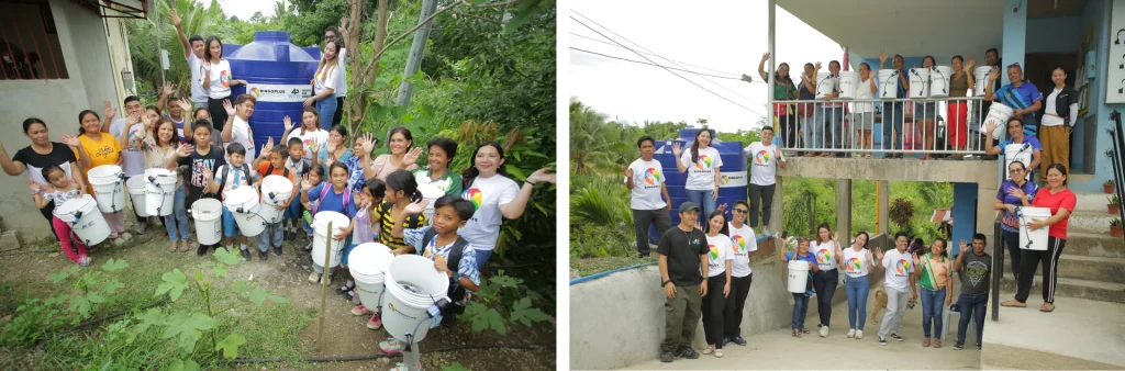 Residents and BingoPlus Foundation volunteers wave beside water tanks while holding their new water filter buckets